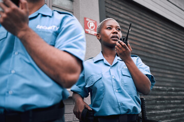 Security, walkie talkie and a black woman police officer in the city during her patrol for safety...