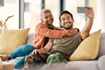 Home, selfie and couple on a couch, love and happiness with romance, relationship and marriage. Social media, black woman and Asian man on a sofa, romantic and memory with profile picture and relax - Powered by Adobe