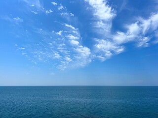 Blue sea, sky, clouds, horizon, calm water.
