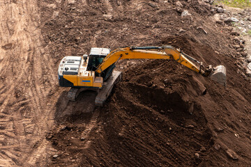 Excavators excavate earth at the construction site