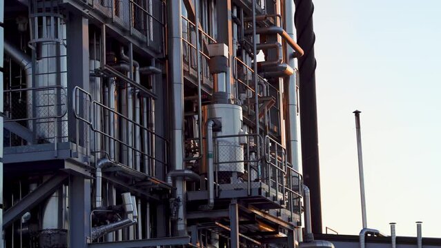 Industrial Pipelines details up close during sunset at paper mill factory in Northern Sweden.