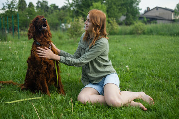 Beautiful blonde smiling happy young woman in denim shorts are sitting at glass and training a red...