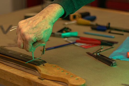 Unstrung Guitar Fretboard and Measuring Tools with Green Lighting, Refretting, Wood Shop, Musician, Luthier Concept