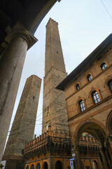 Bologna, Italy: Torre Asinelli, Two towers in old town of the city across the cloudy sky, Travel destinations © Kate