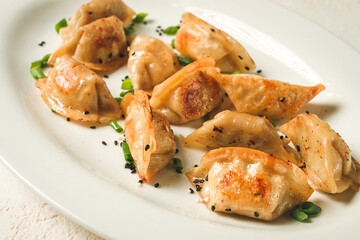 japanese fried gyoza dumplings, with pork, sesame seeds, green onions,