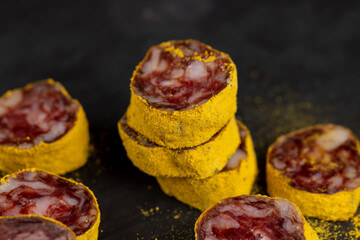 marinated in young turmeric pork sausage on black slate