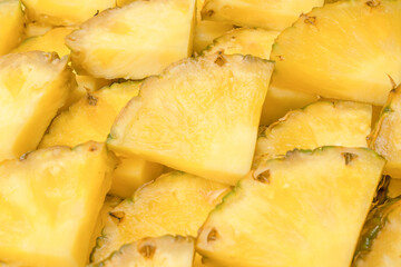 Pineapple juicy yellow slices as a background.