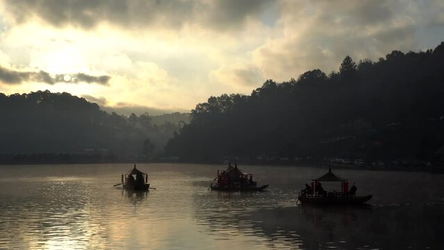 ban ruk thai Yunnan village of Thailand, mae hong son province chinese boat in morning golden sunrise lake with fog
