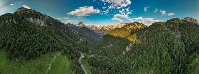 Fototapeta na wymiar Alpine landscape with green forest in Predil Pass, Italy and Slovenia. Aerial drone view