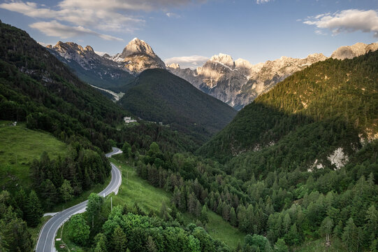 Alpine landscape with green forest in Predil Pass, Italy and Slovenia. Aerial drone view