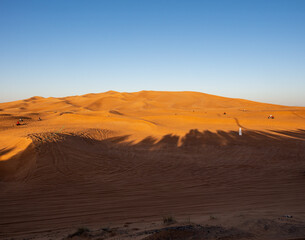 Fototapeta na wymiar Tourists in Dubai desert on a sunny day in UAE