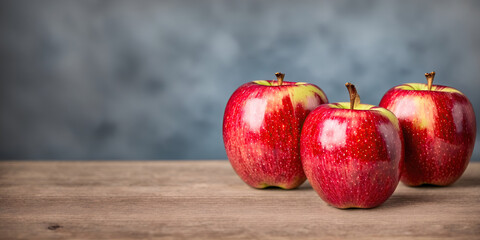 Red apples close-up on the table on a gray background.
