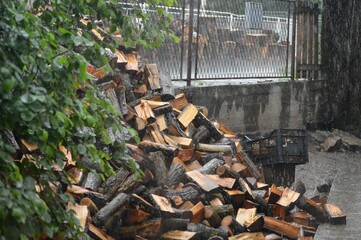 firewood in a pile in the rain