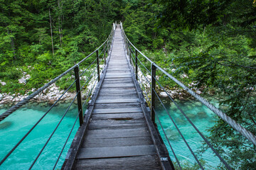 Suspension bridge in Soca valley over Soca river in Slovenia