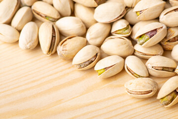 Pistachios on wooden table. Fresh tasty pistachios close up
