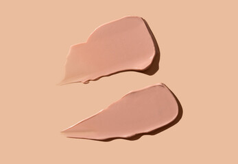 Cosmetic smear of cream texture on a beige background. Toning cream for the skin. Skin care.