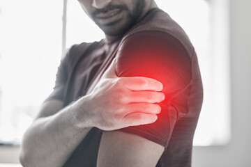Hand, arm pain and injury with a man shoulder in red highlight during a fitness workout....