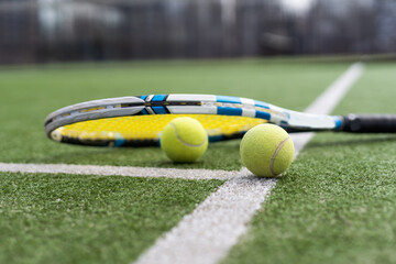Close up of tennis rackets and tennis balls lying on tennis court. sport, tennis and activity.
