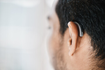 Hearing aid, closeup or ear of man with disability from the back on mockup space. Deaf person,...