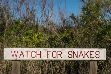 Close-up of sign in public land reading "Watch for Snakes"