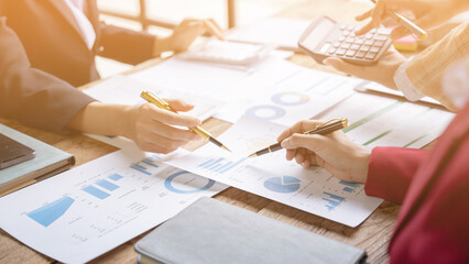 Financial analyst analysis business financial report on digital tablet during discussion at meeting of corporate showing the results of their successful teamwork, business meeting concept, Marketing