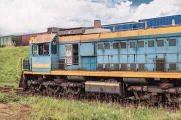 Blue freight diesel locomotive for the movement of freight cars on the railroad. Transportation of goods by rail. Diesel locomotive. Maneuvering composition.