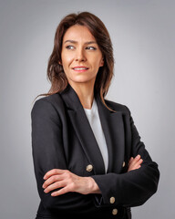 Brunette haired mid aged woman wearing business casual and standing at isolated background