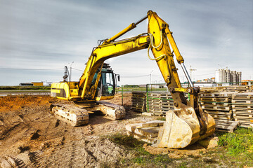 A powerful crawler excavator is working on a construction site. Close-up. Preparation of a pit for construction. Excavation.