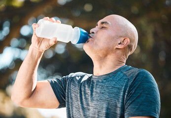 Fototapeta na wymiar Man, drinking water and hydration in fitness after workout for nutrition, sustainability or thirst in nature. Tired and thirsty male person with healthy beverage for running, exercise or training