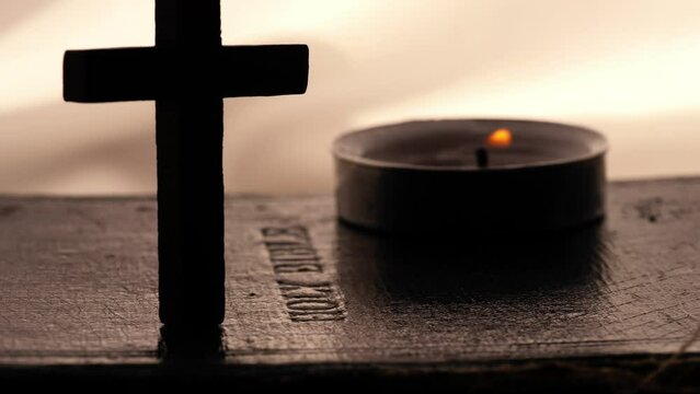 Holy bible with crucifix and tea light candles 