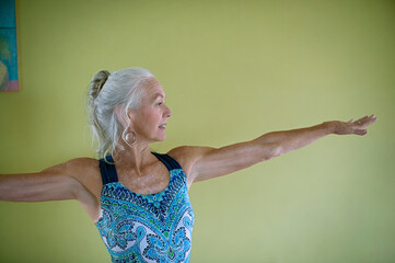 Senior woman in a beautiful yoga studio.