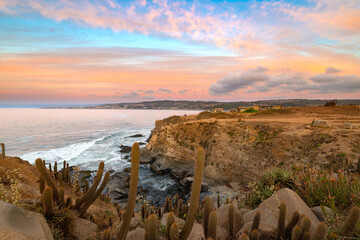 Cliff in Punta de Lobos with the town of Pichilemu in the back, VI Region, Chile
