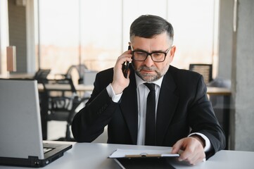 Angry manager throwing away his phone in his office