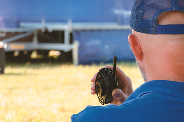 Security guard with a walkie-talkie in an outdoor cinema.