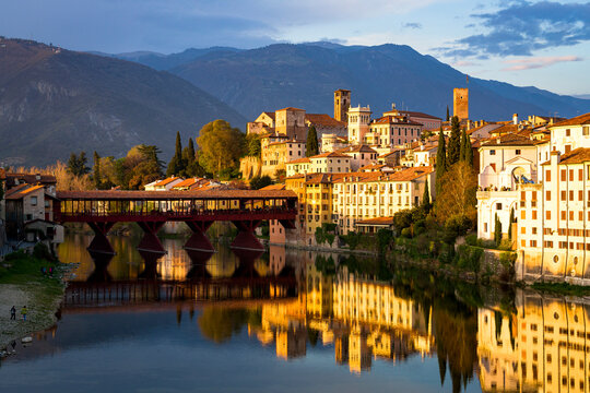 Sunset over the iconic Ponte Vecchio bridge reflected in river Brenta, Bassano Del Grappa, Vicenza province, Veneto
