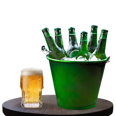 Glass of beer and a ice bucket with beers isolated on white background