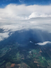 clouds over green farmland