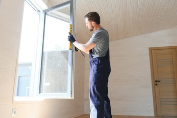 Process of construction new and modern modular house from composite sip panels. Worker man in special protective uniform wear working on building development industry of energy efficient property.
