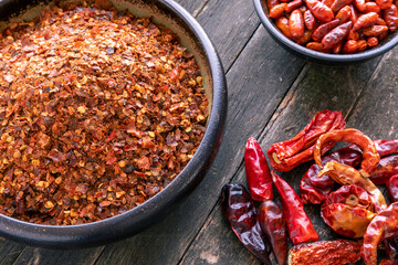Homemade chili flakes with seeds made of toasted (dry roasted) dried chilies of different...