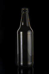 Empty beer bottle close up on black background