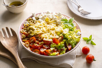 Pasta salad. Traditional Italian pasta salad with cherry tomatoes, olives, feta cheese, green cabbage.