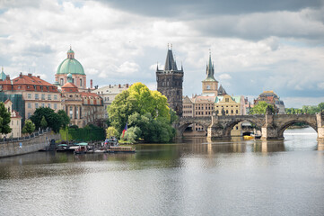 Scenic view on Vltava rive, Charles bridge and historical center of Prague, buildings and landmarks...