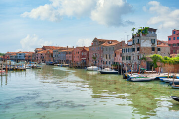 Fototapeta premium Boatyard with many boats on the water in Venice, Italy. Scenic landscape in Venice.