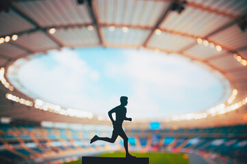 Focused on the Track and Field: Silhouette of a Male Athlete, a Dedicated Runner, Piercing through the Dusk towards Victory at a Modern Sports Stadium