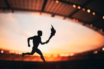Silhouette of Male Athlete Leading the Relay, with a Modern Track and Field Stadium as the Striking Backdrop. A Captivating Photo for the Summer Game 2024 in Paris.