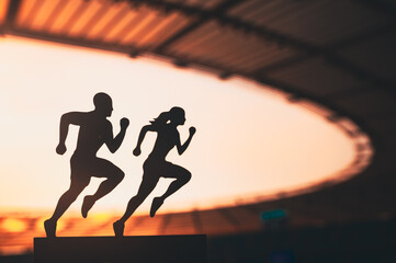 Synchronized Strides: Silhouettes of Male and Female Runners in Tandem, Gracefully Racing against a Modern Sports Stadium Backdrop