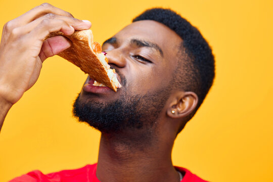 man delivery black food eat food happy masculine guy smile background fast pizza