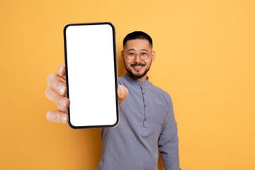 Handsome Asian Man Demonstrating Big Blank Smartphone In His Hand