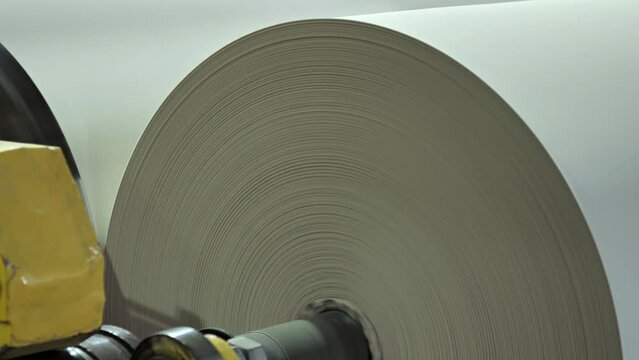 Factory for the production of paper rolls for hygiene. Manufacture of paper towels and toilet paper. Roll winding machine.