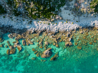 aerial view from the drone of a Caribbean and crystalline sea with the sheer cliff. This image conveys a sense of peace and tranquility immersed in unspoiled nature